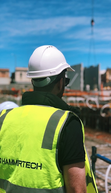 construction-crew-member-in-hammertech-safety-vest-389x674